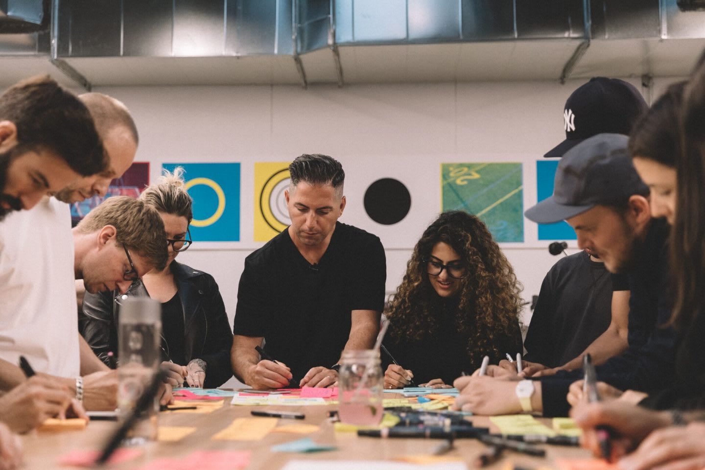 group of people taking notes on sticky notes