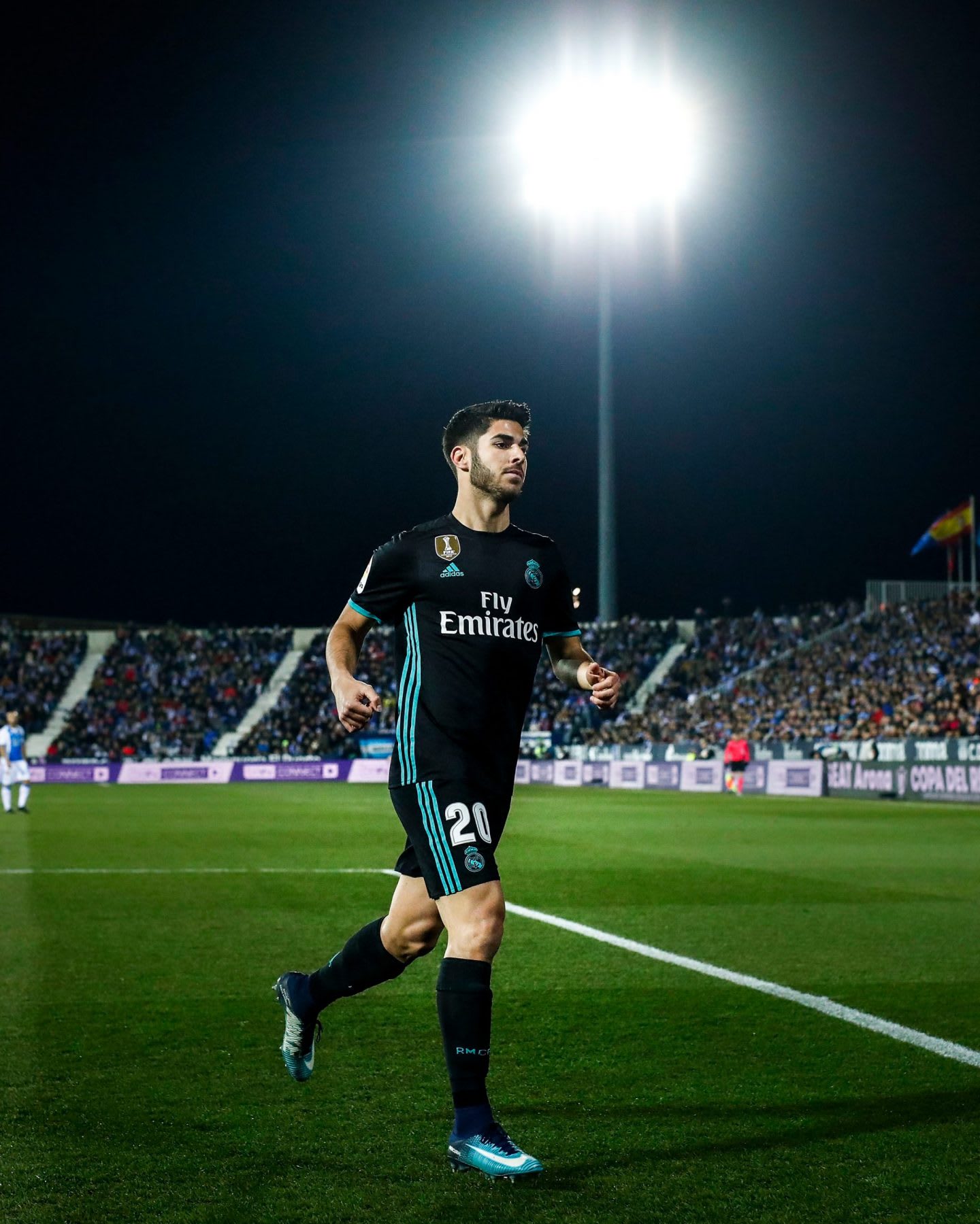 Marco Asensio in the spotlight in a football stadium