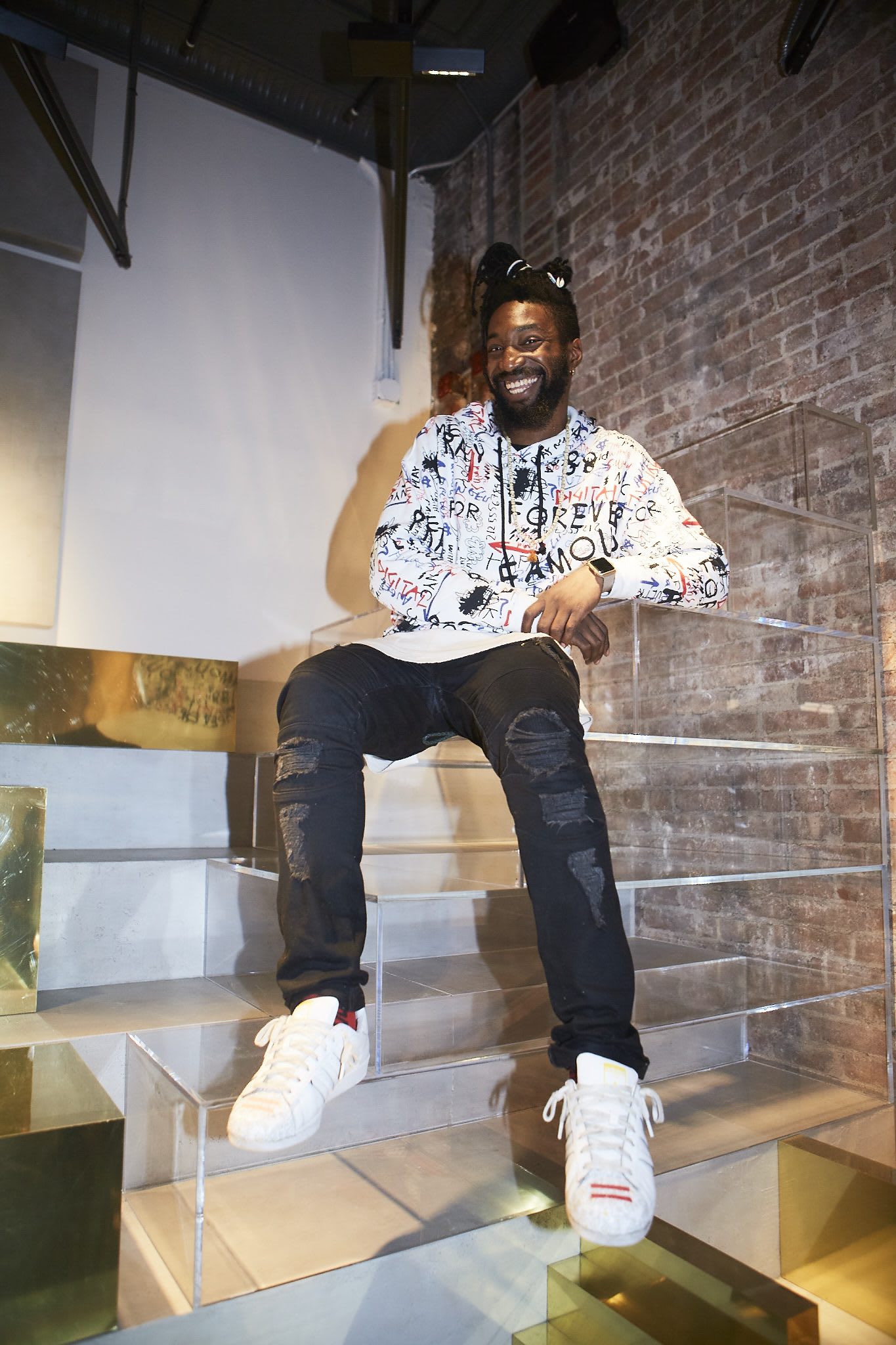 man laughing sitting on stairs creator minds in NYC