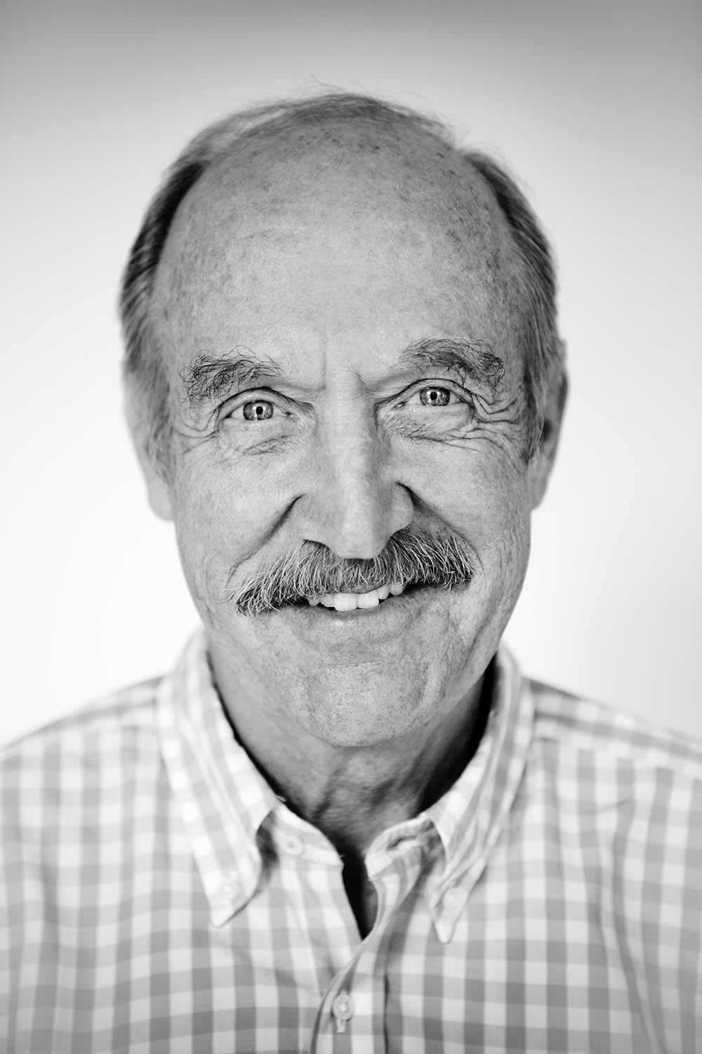 man with mustache laughing stan smith dream goals to achieve greatness
