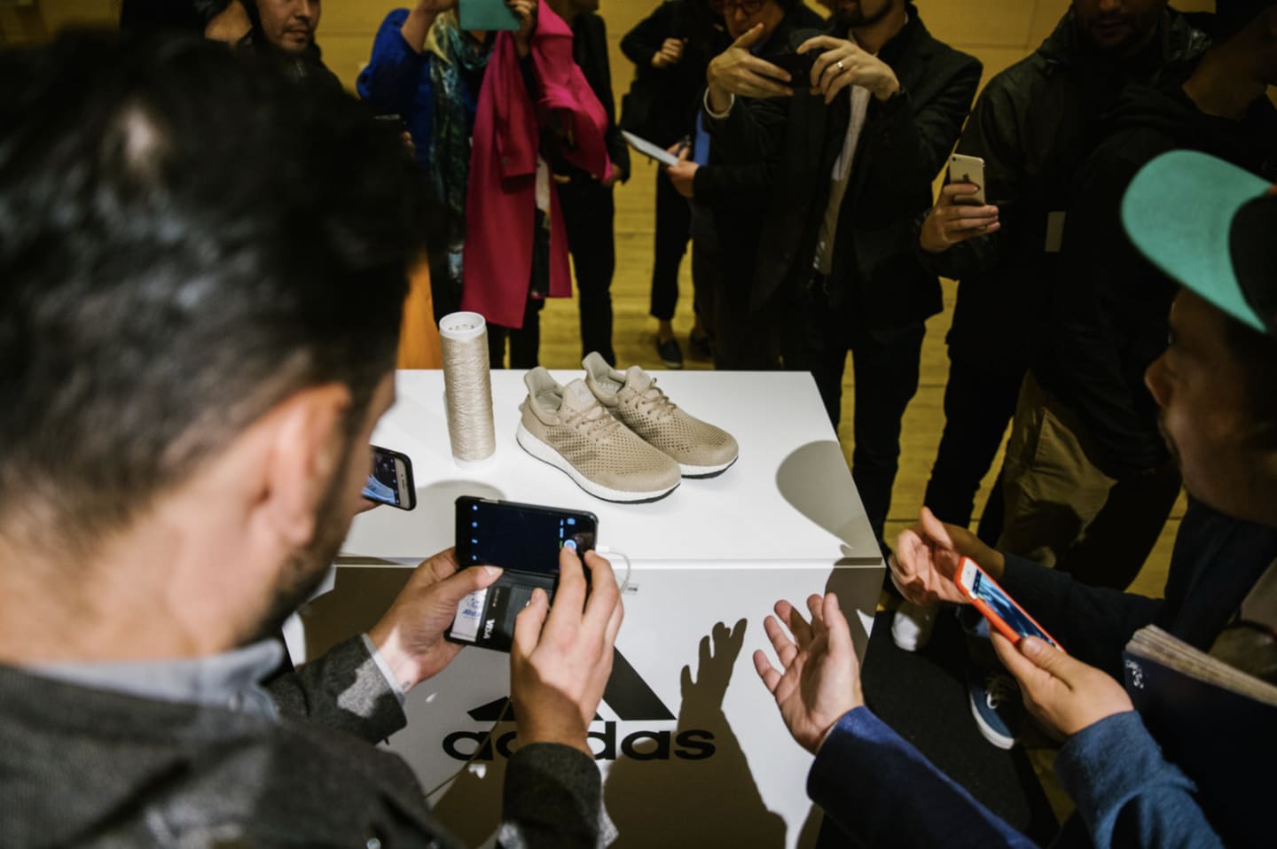 people taking picture of shoe biofabricate for better future
