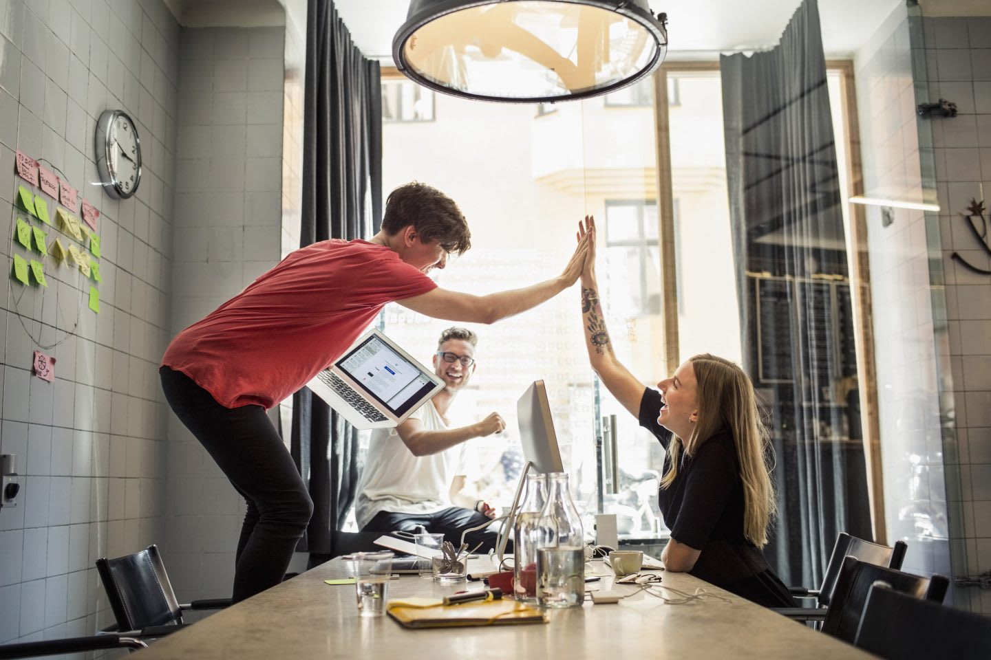 happy colleagues giving high five in office motivate team know what makes them tick