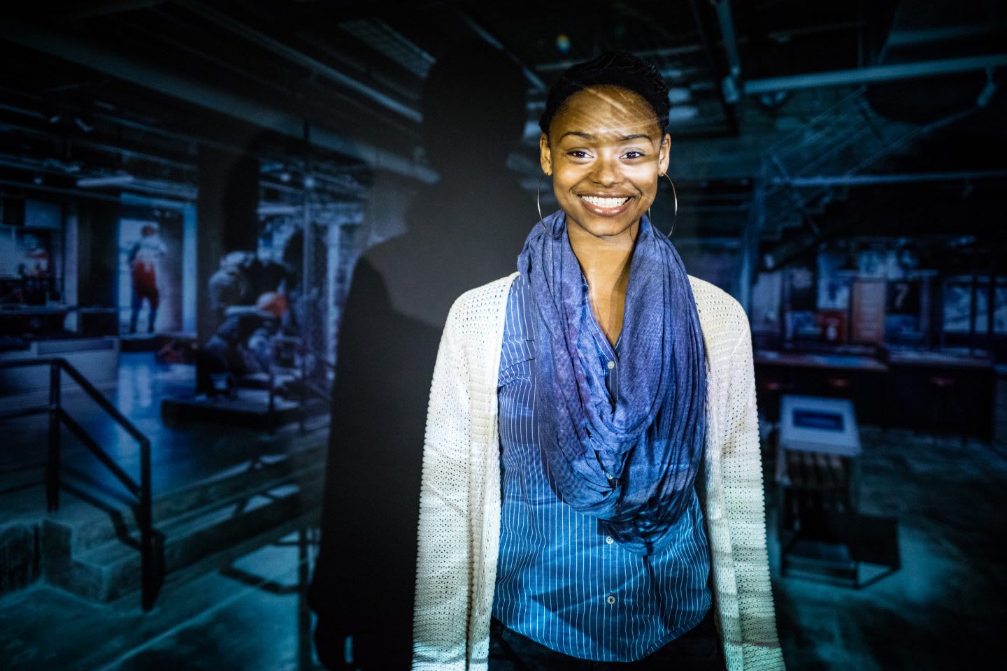 woman smiling with projection behind her