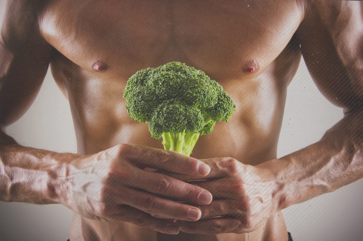 Muscular Caucasian athlete holding broccoli, nutrition, health, adidas, GamePlan A
