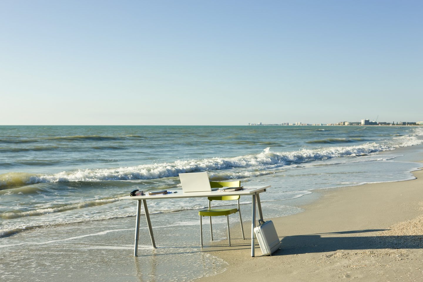 Desk and laptop computer on beach