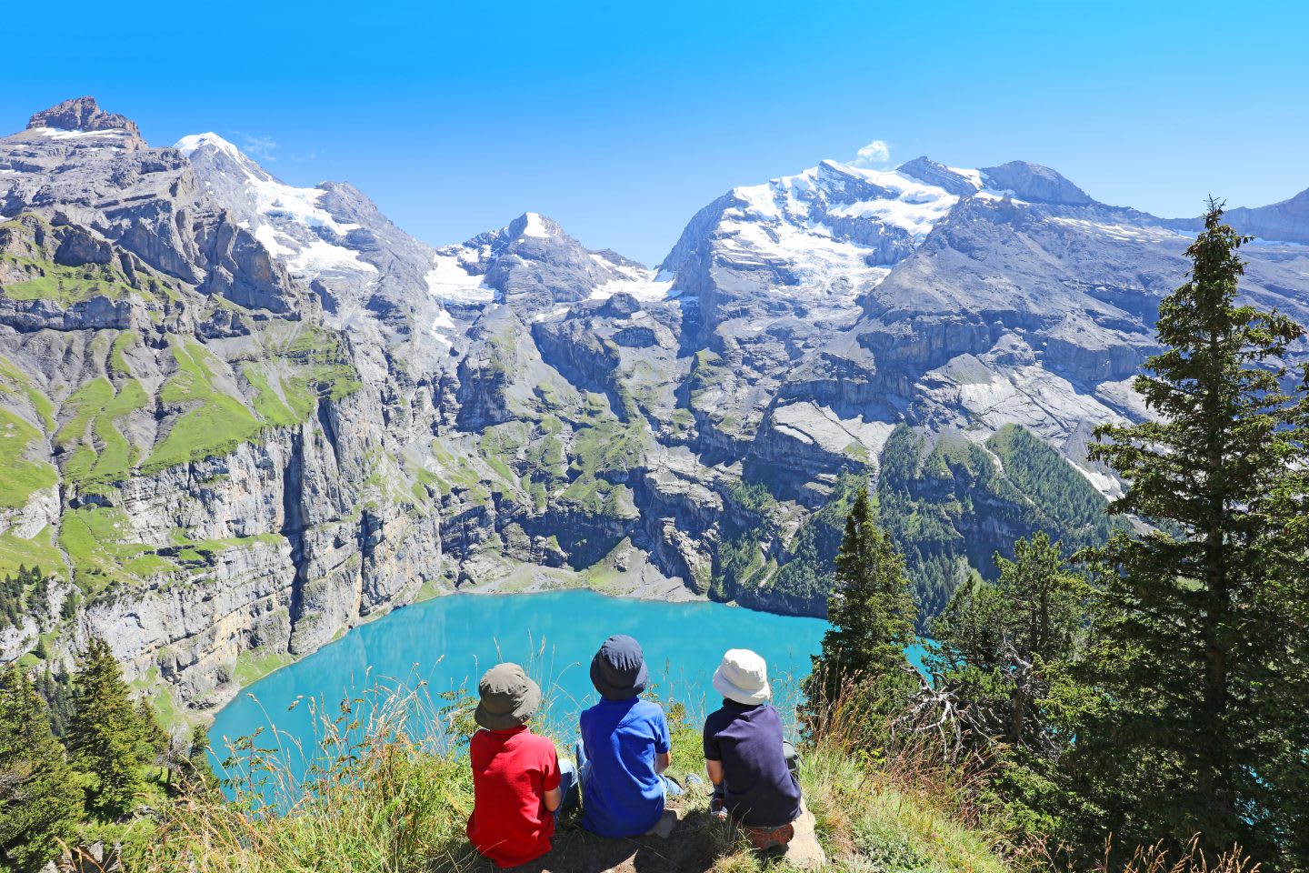 Children Hiking in Swiss Mountains Admiring Scenic Landscape at Oeschinensee
