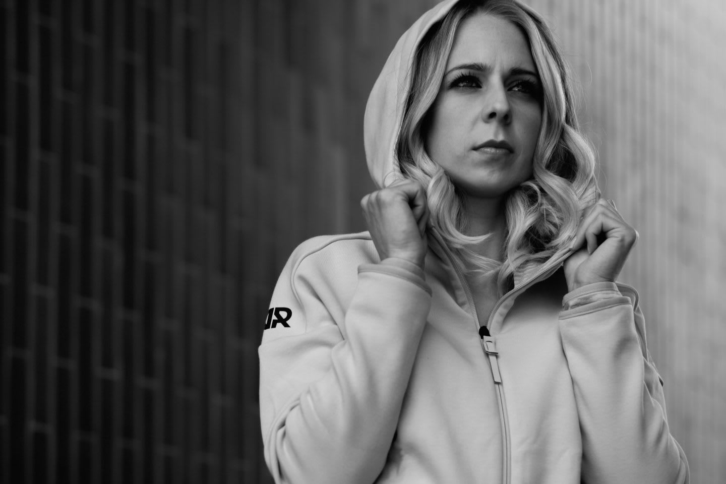 black and white picture of a woman looking concentrated and wearing an adidas Runners track top in front of a black background, Larissa Gerhard_adidas Runners_GamePlan A