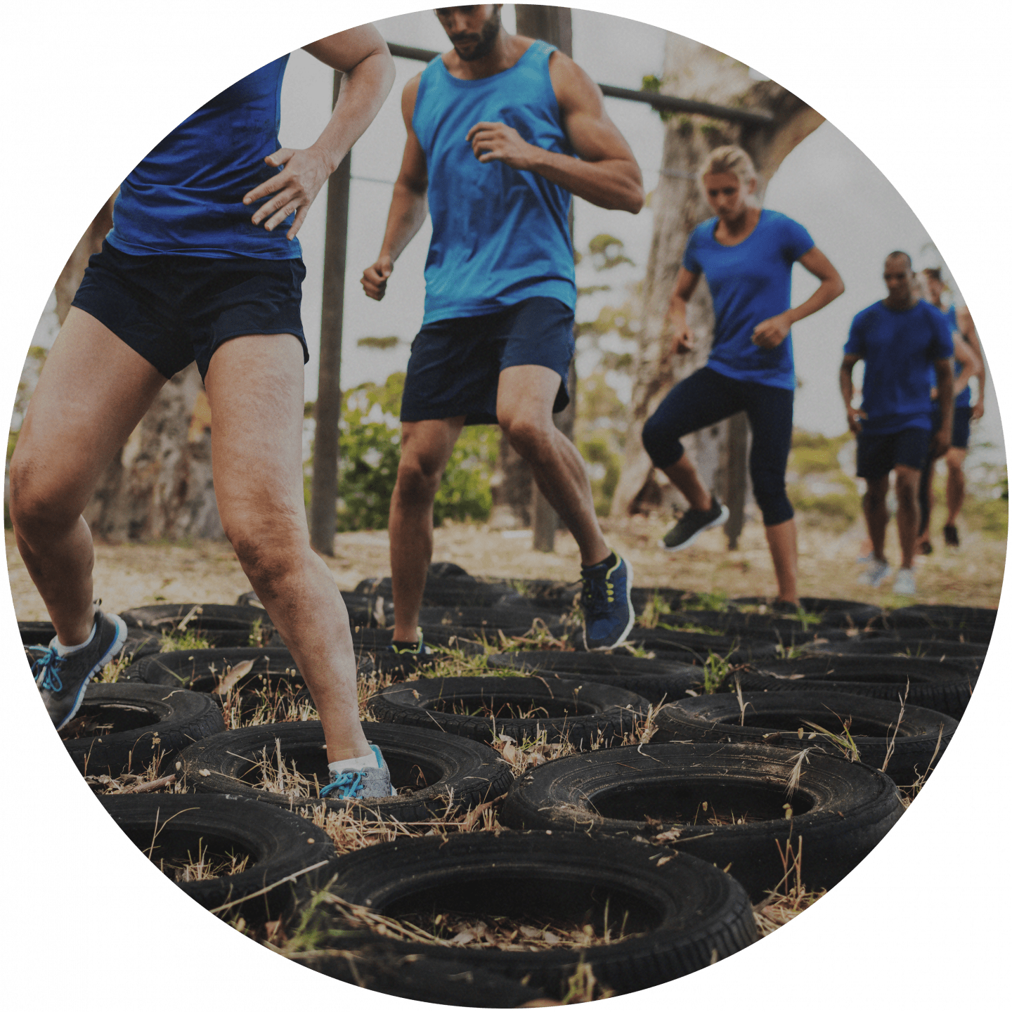 Sporty people running through an obstacle parcours with old car tires. team building, obstacle race, team event, business, fitness, bonding, Outdoor_Fitness Circuit_Obstacle race, adidas, GamePlan A