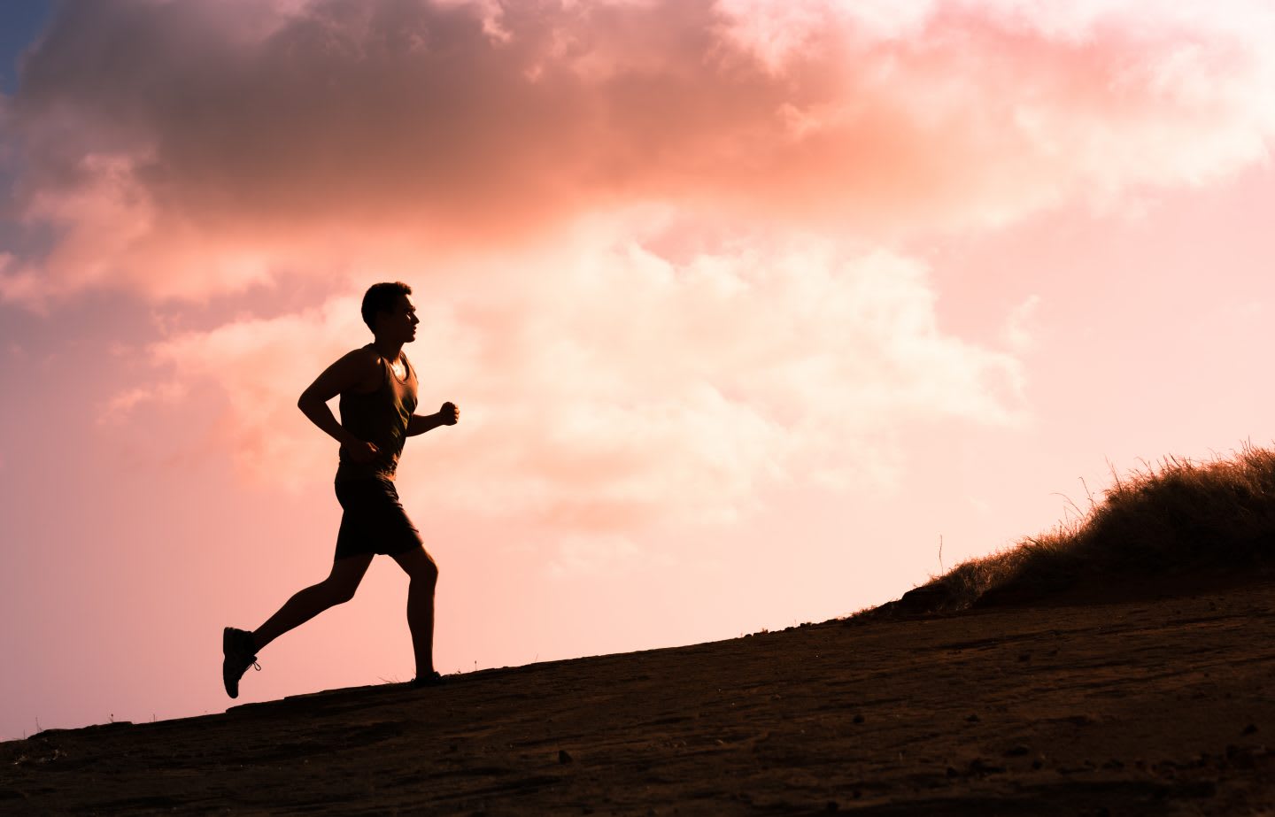 Man running outside in the sunrise to feel free