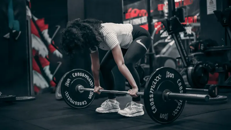 a member lifting a free weight with correct form