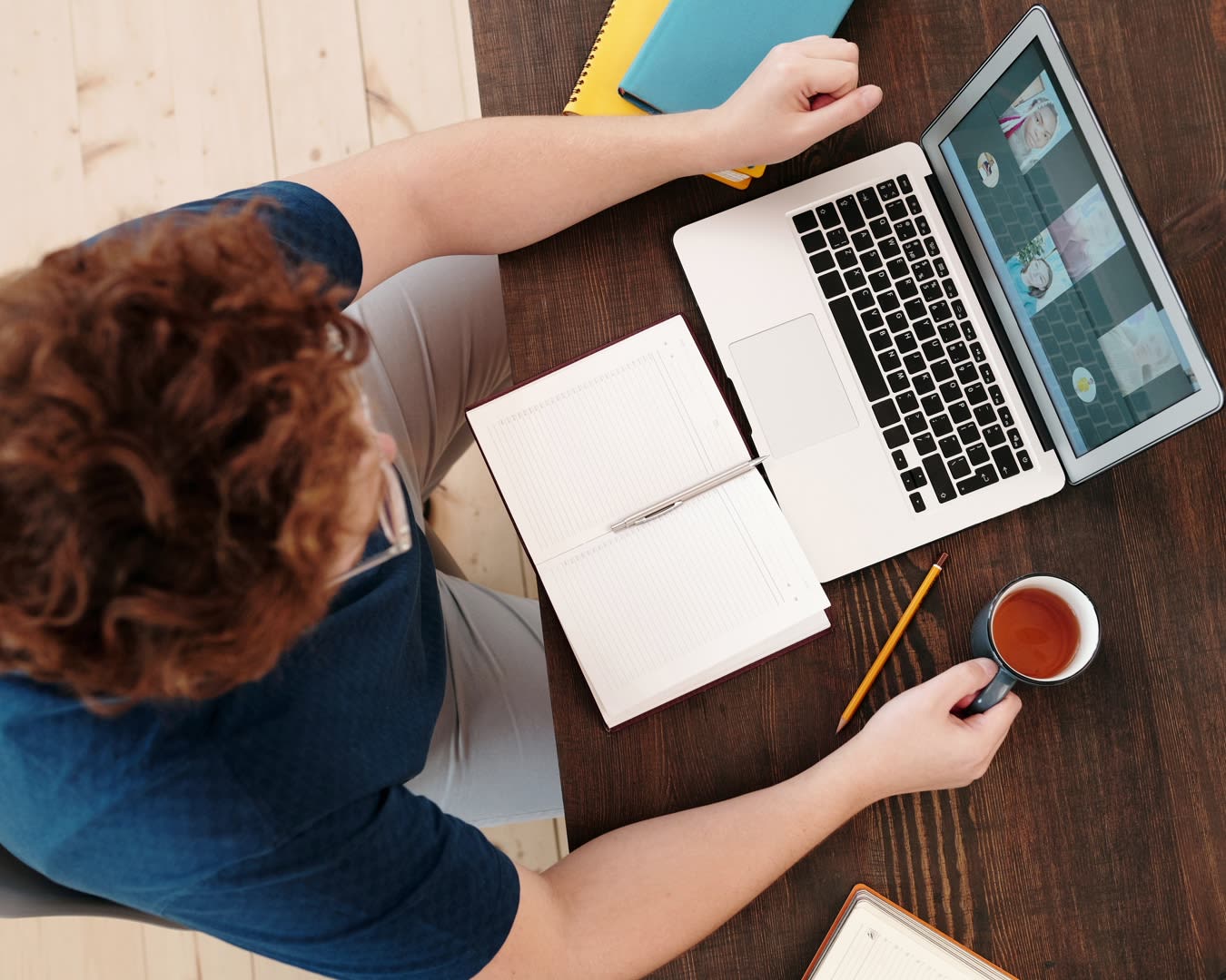 Remote worker collaborating with a team through video-conferencing on his laptop.