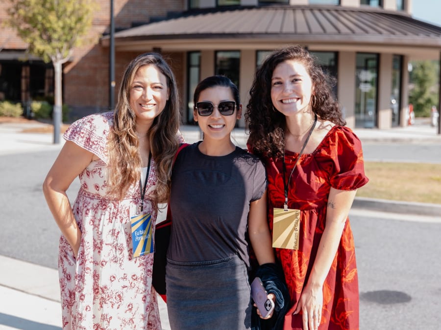 Three friends together outdoors in the summer sun at Futures Alpharetta