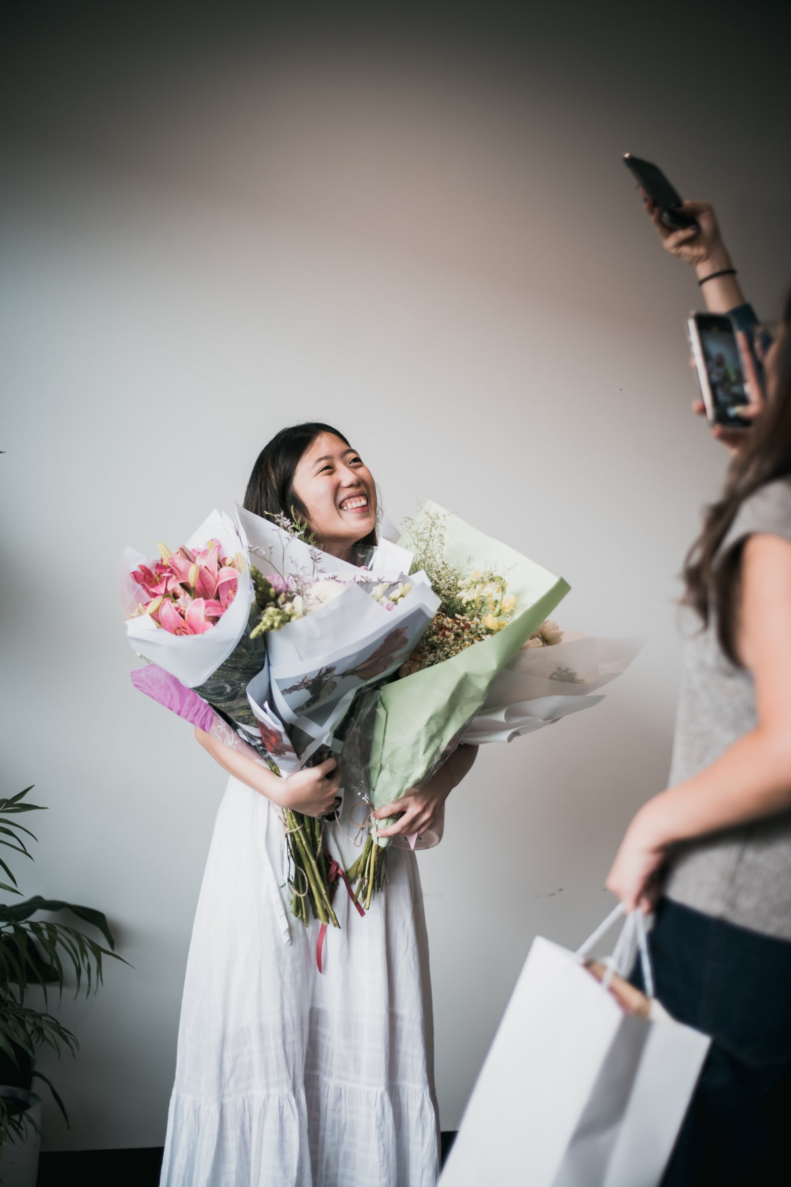 Asian Woman Holding Four Bouquets of Flowers