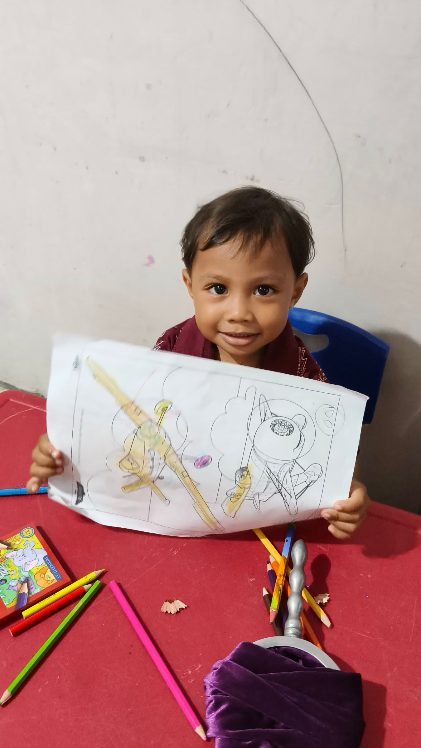 cemani boy showing drawing