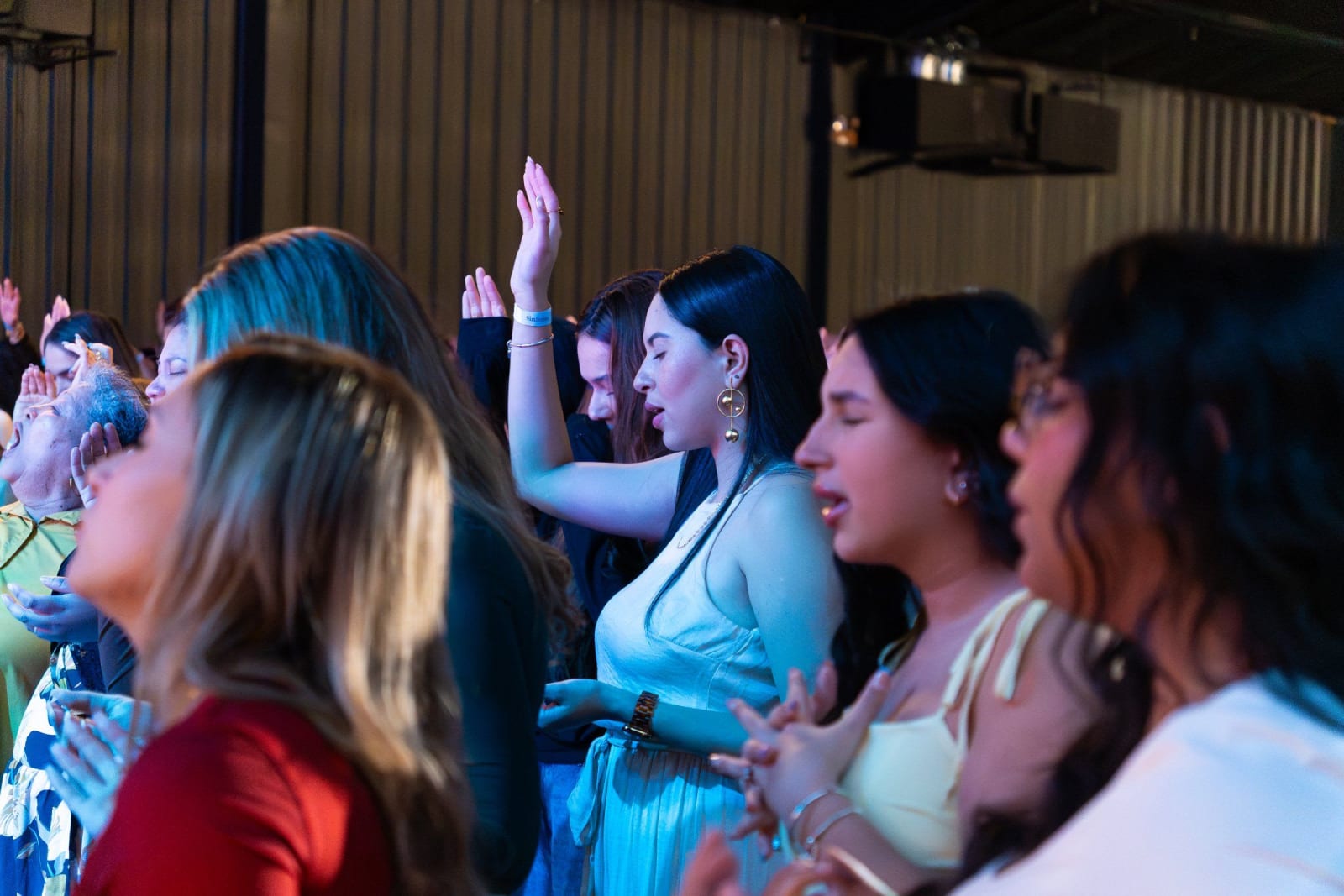 People worshipping with hands raised / duluth
