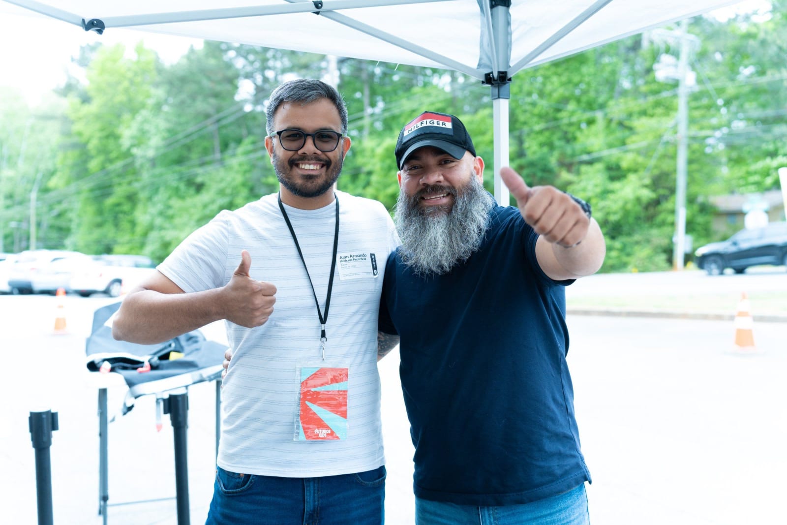 Two men giving a thumbs up at an event / duluth