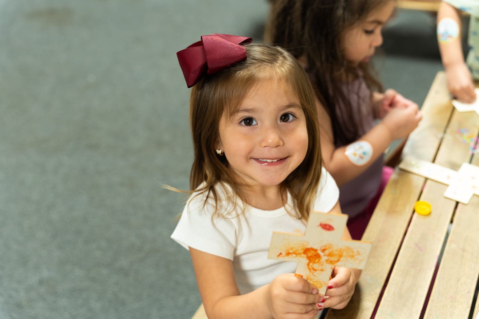 A young girl eating pizza at a table / duluth