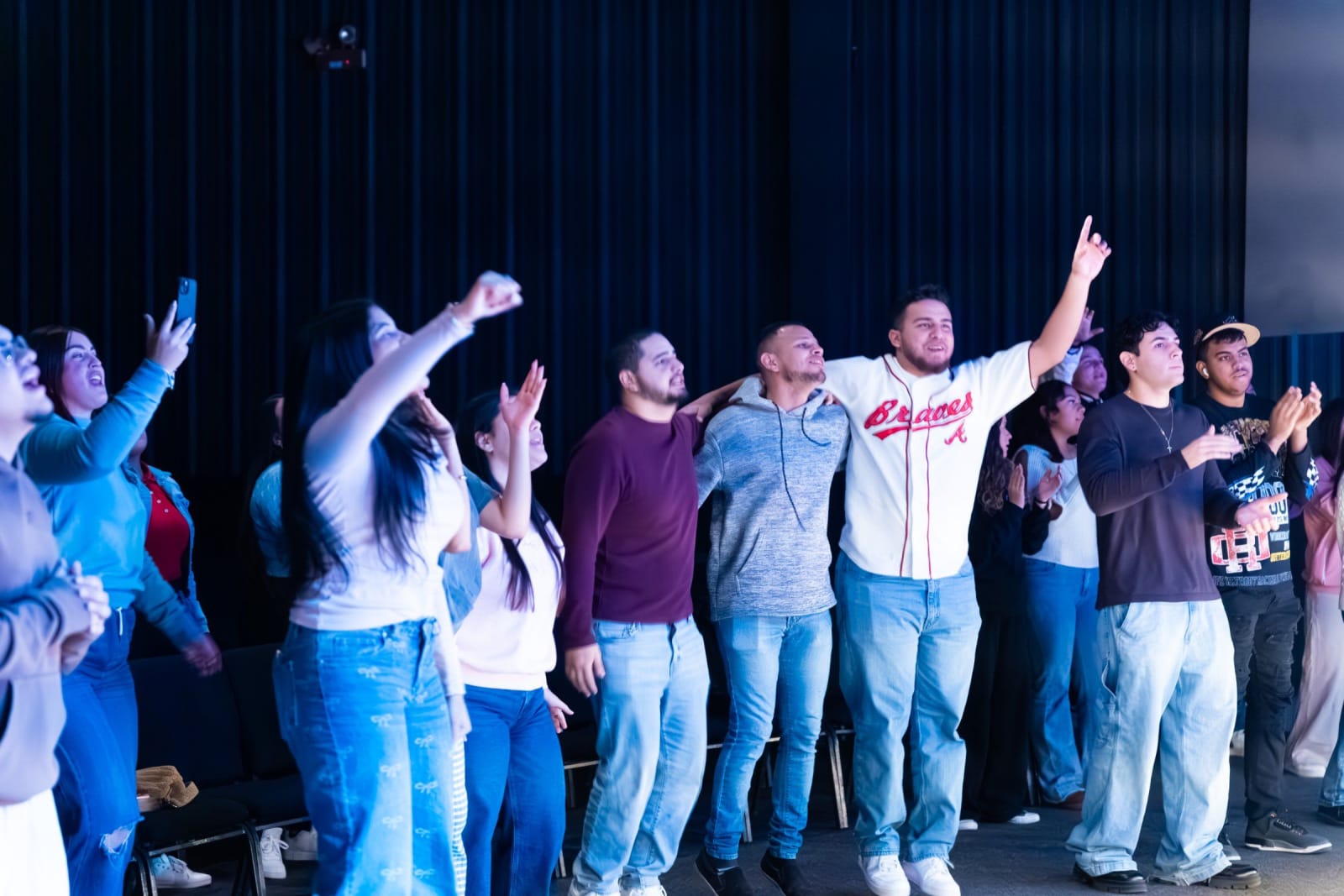 Young people with arms raised in worship / duluth