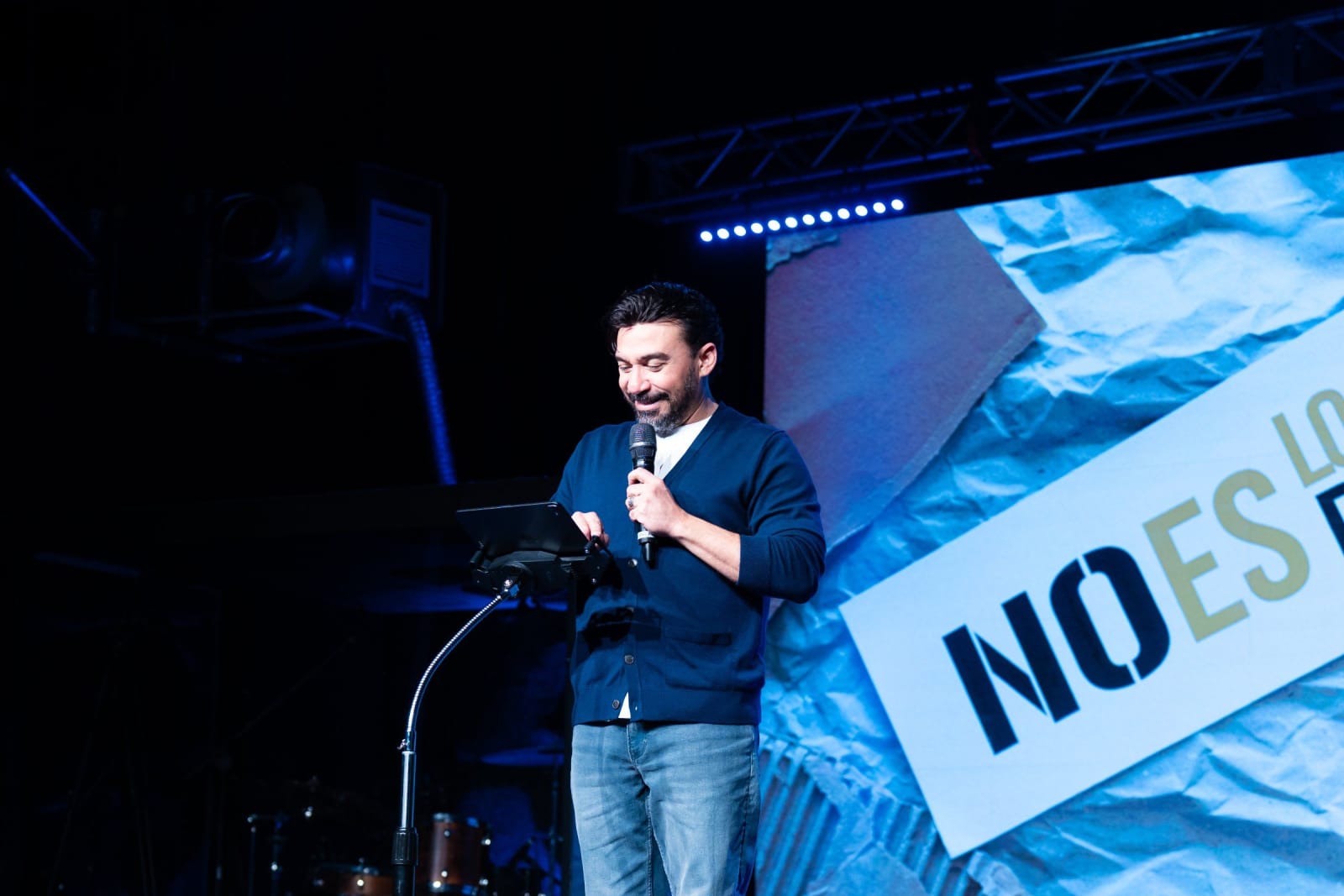 A man speaking into a microphone on stage / duluth