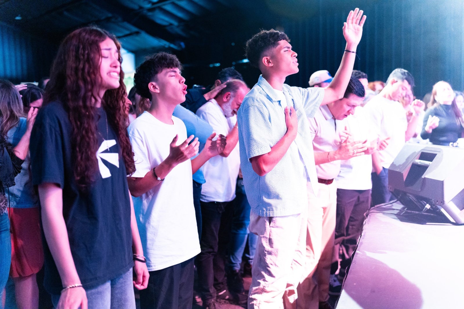 Youth worshipping with hands raised / duluth