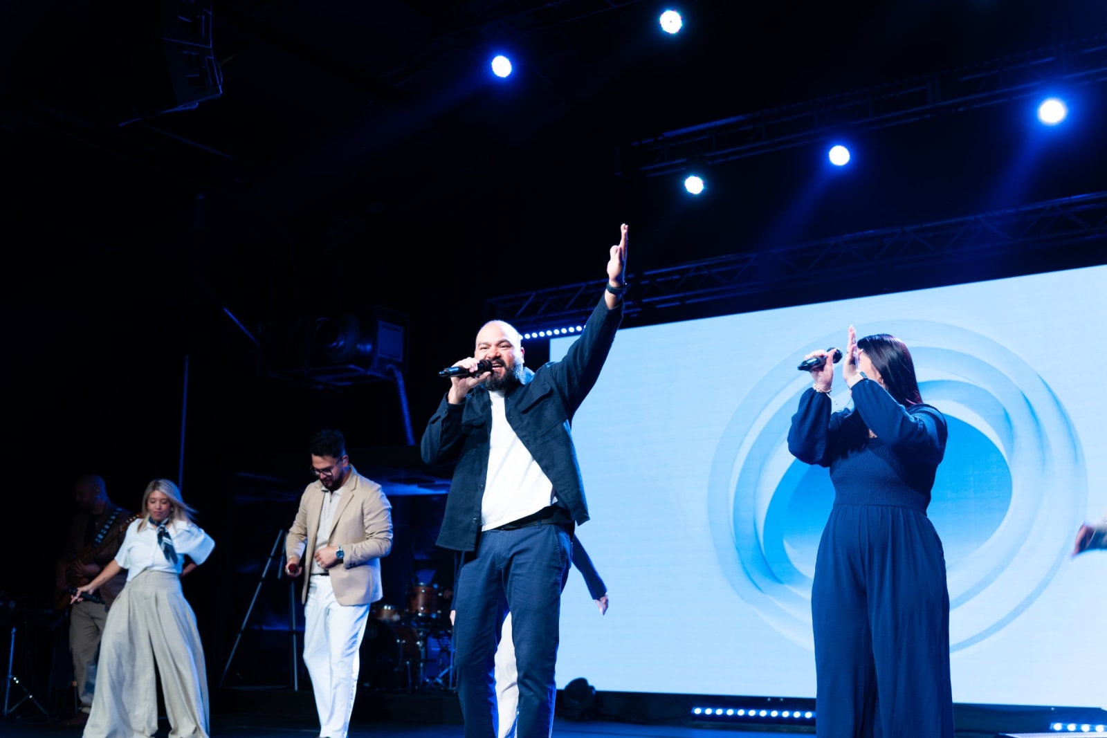 A worship team singing on stage / duluth
