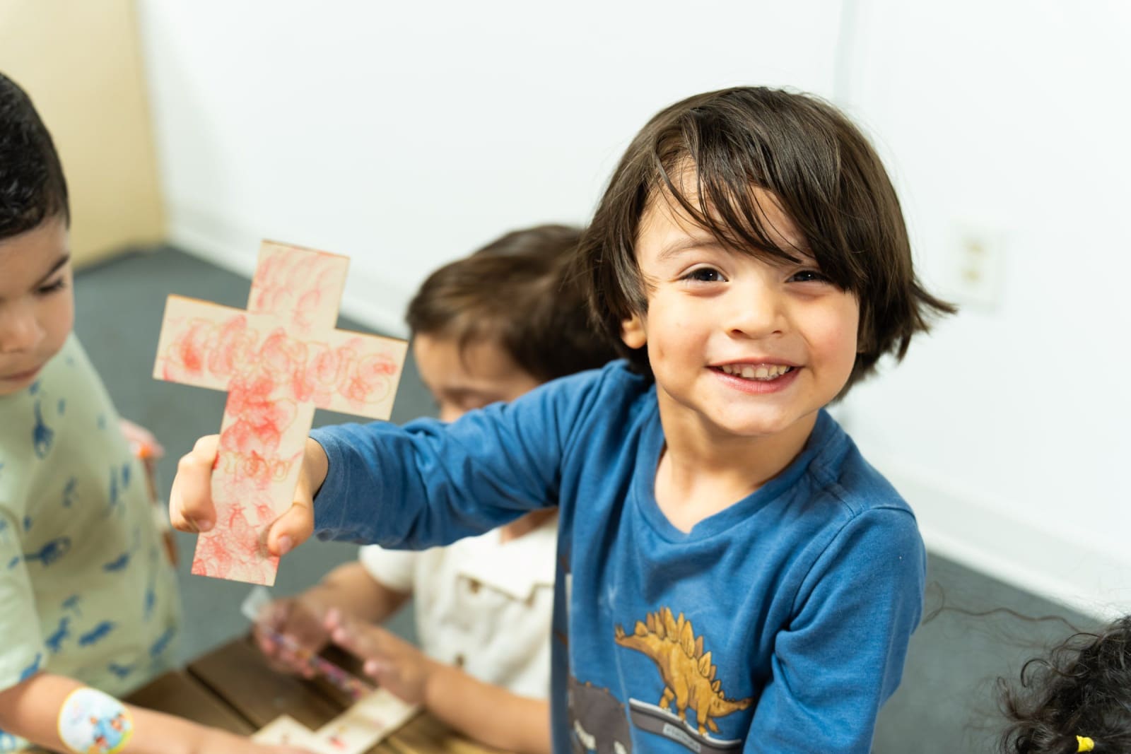 A child holding a paper cross / duluth