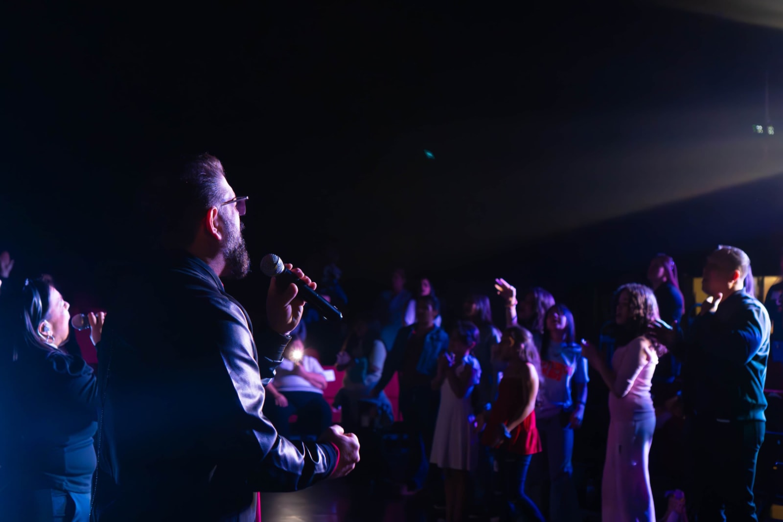 Singer leading worship facing the congregation / grayson