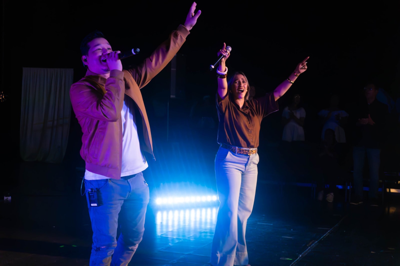 Two worship singers performing on stage / grayson