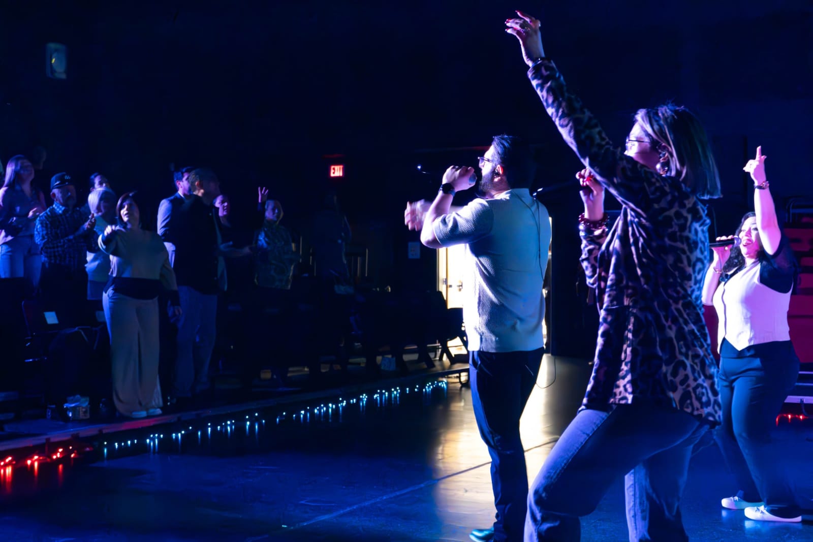 Worship singers leading with raised hands / grayson