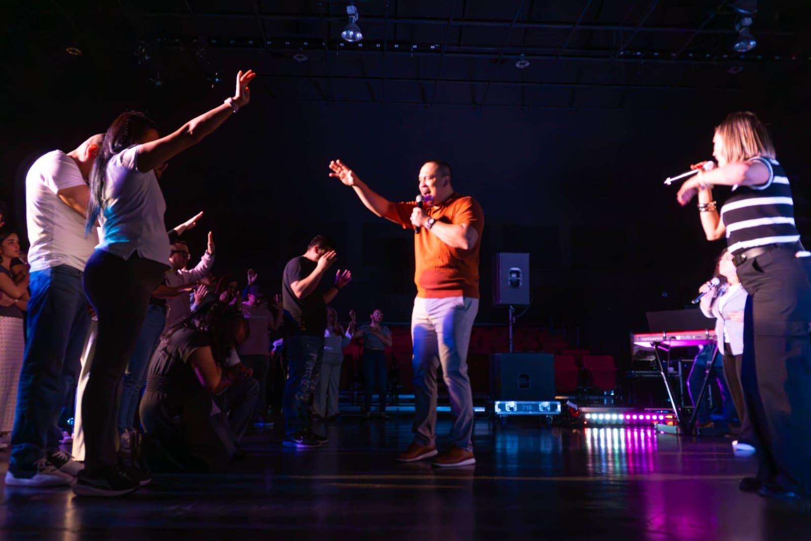 Worship leader singing on stage / grayson