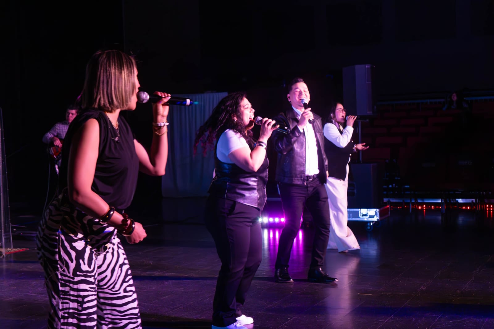 Worship team singing on stage / grayson