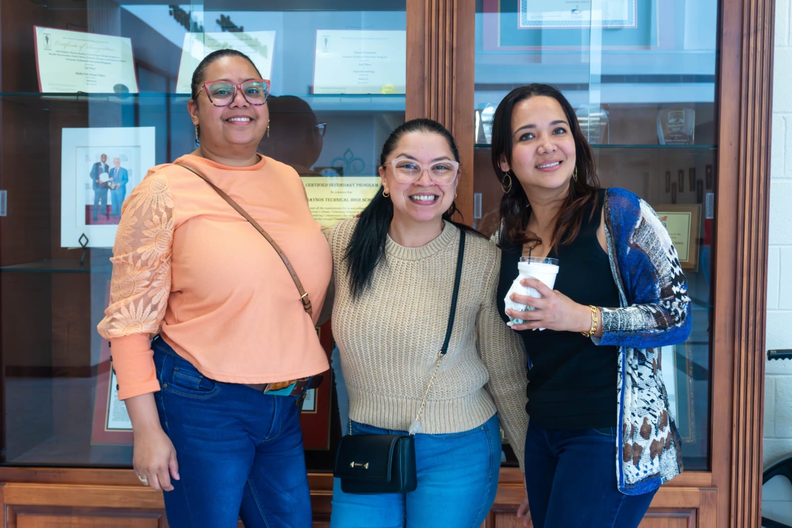 Three women smiling together / grayson