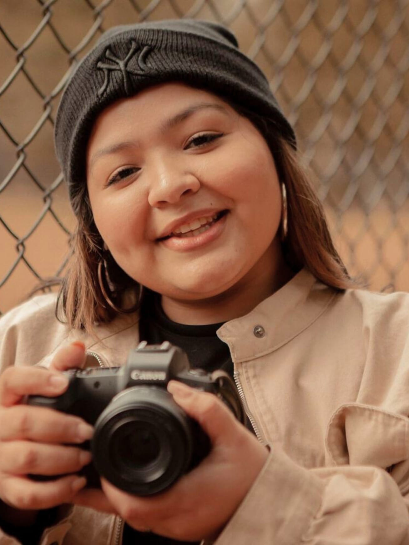 Britt holding a camera and smiling / gwinnett