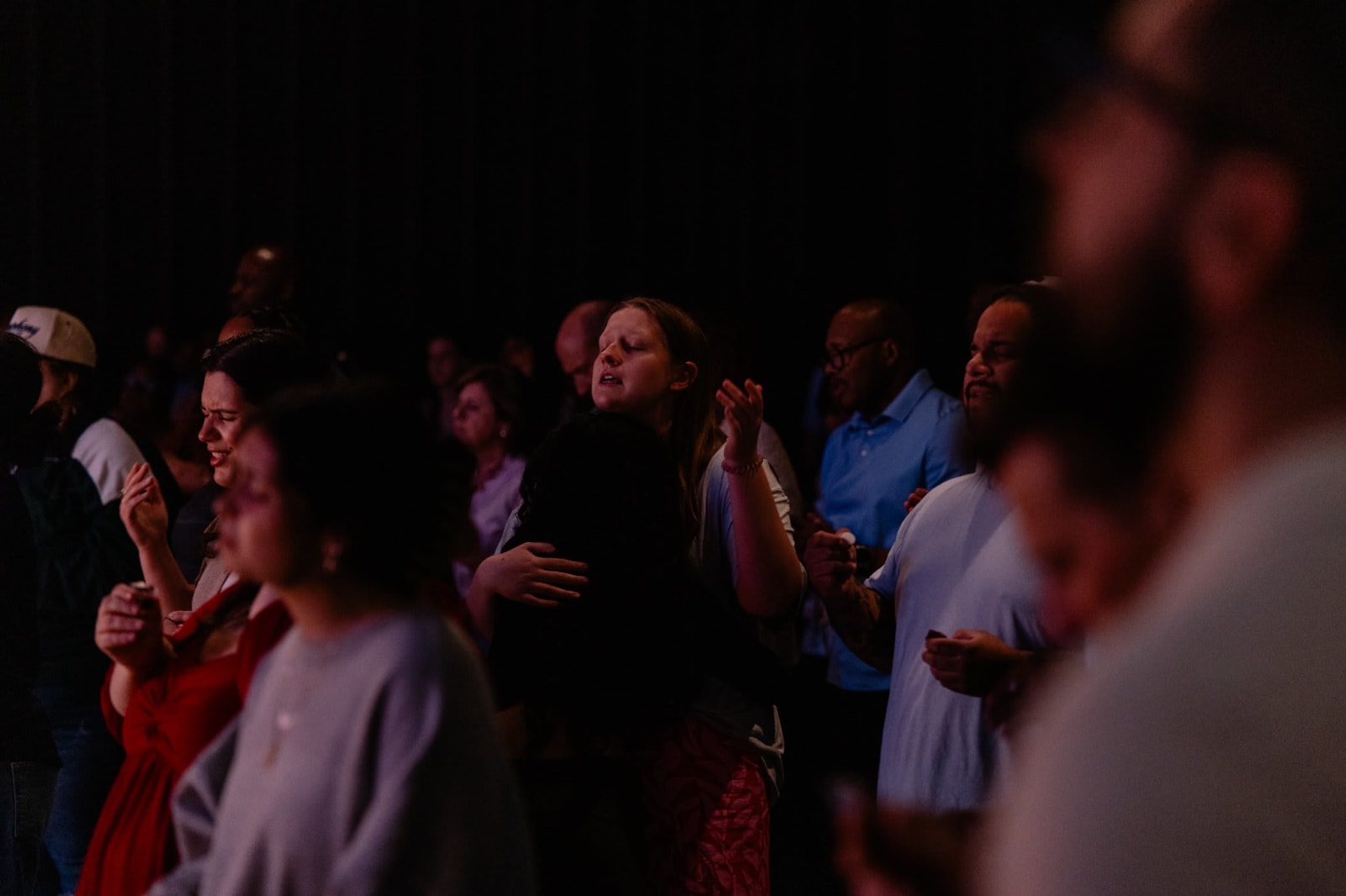 Congregation worshipping with hands raised / Gwinnett