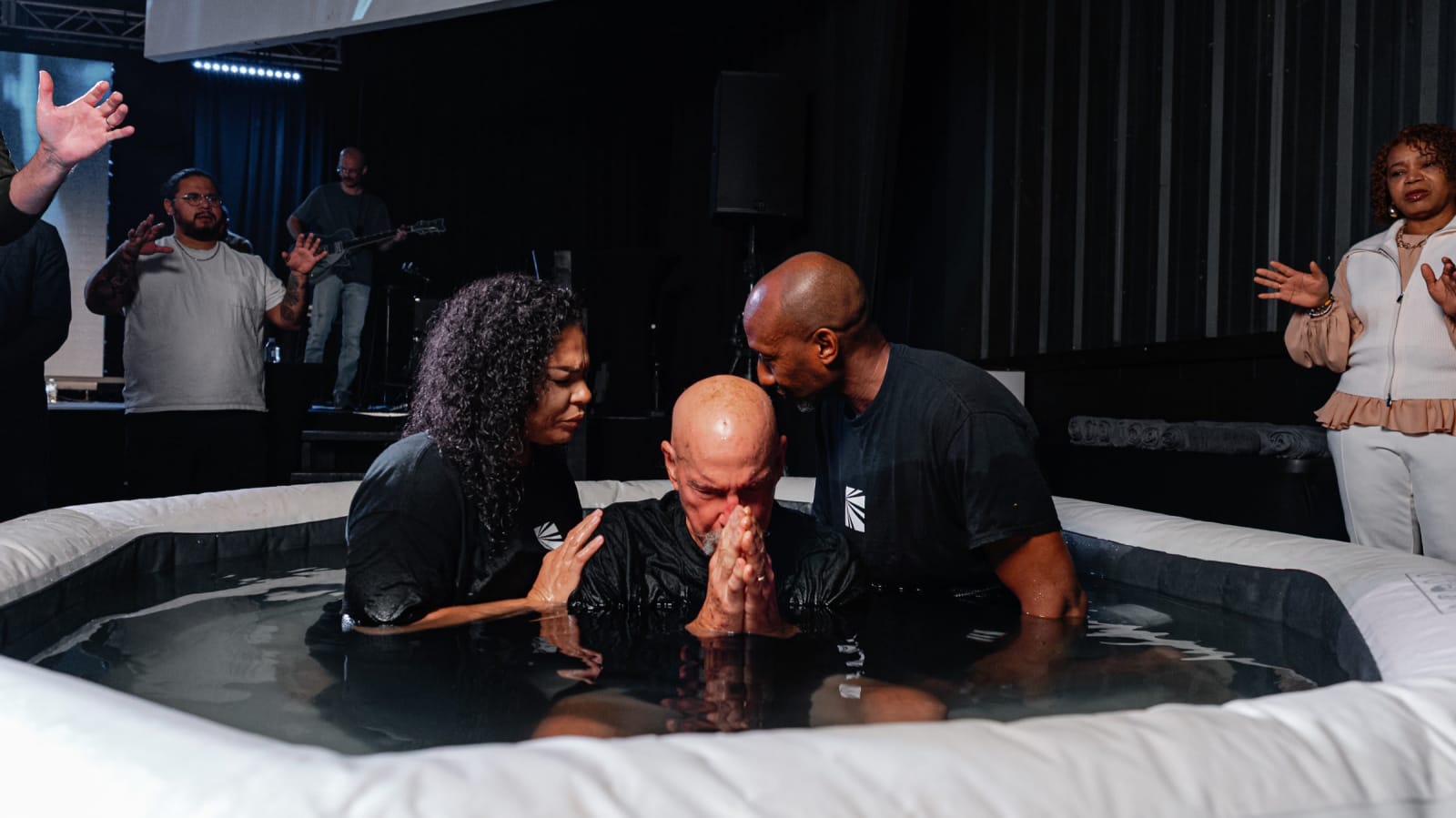 man being baptized in the baptism tank / gwinnett