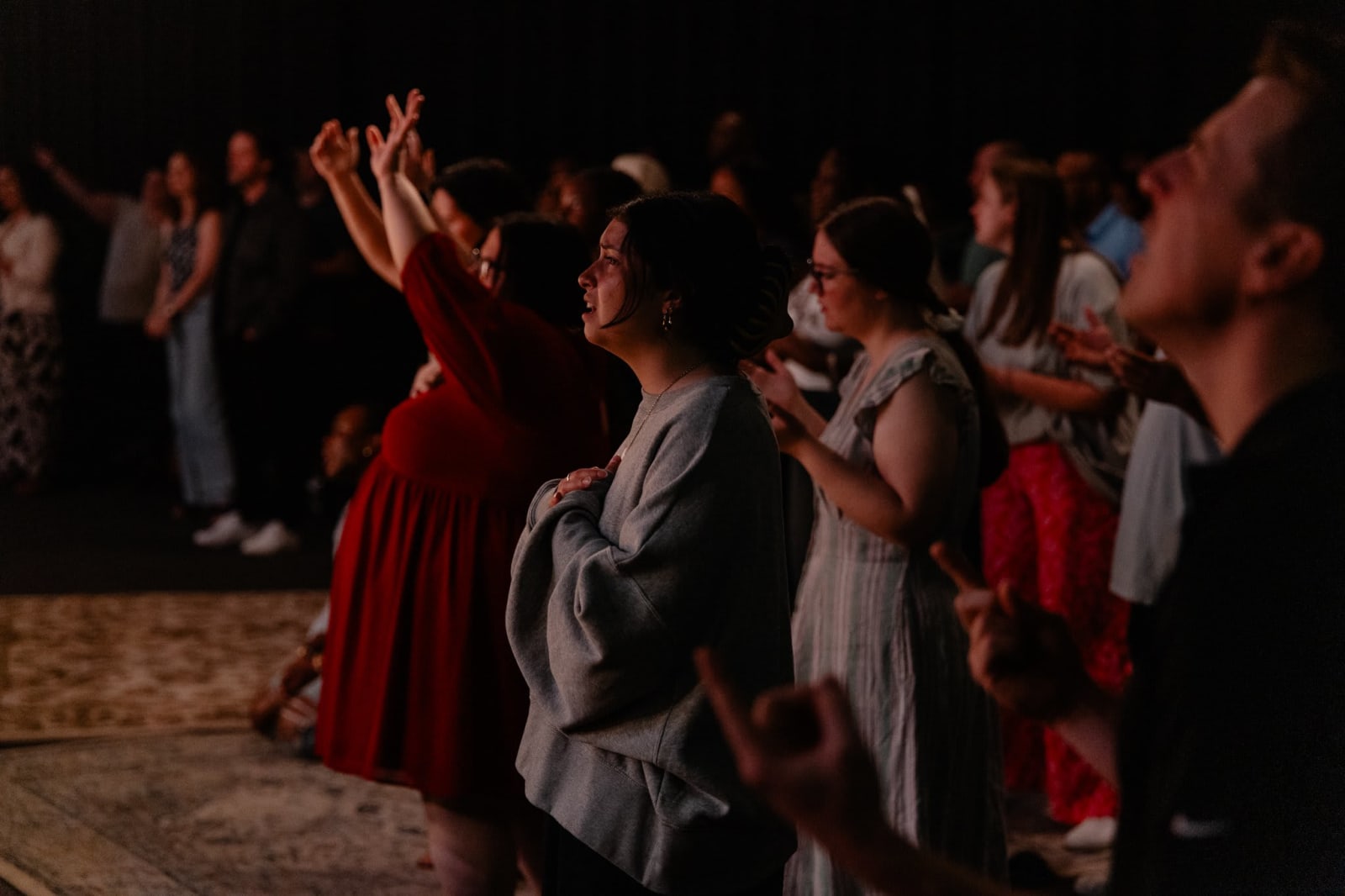 woman in crowd with hand on heart / gwinnett