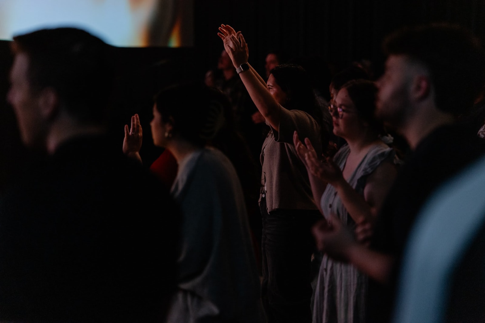 Congregation in worship with hands raised / Gwinnett