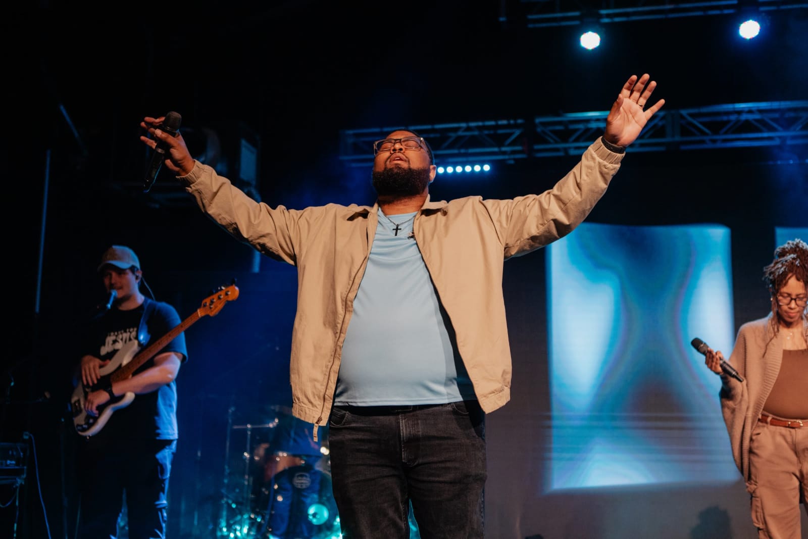 Man worshipping with hands raised  / Gwinnett + Stage