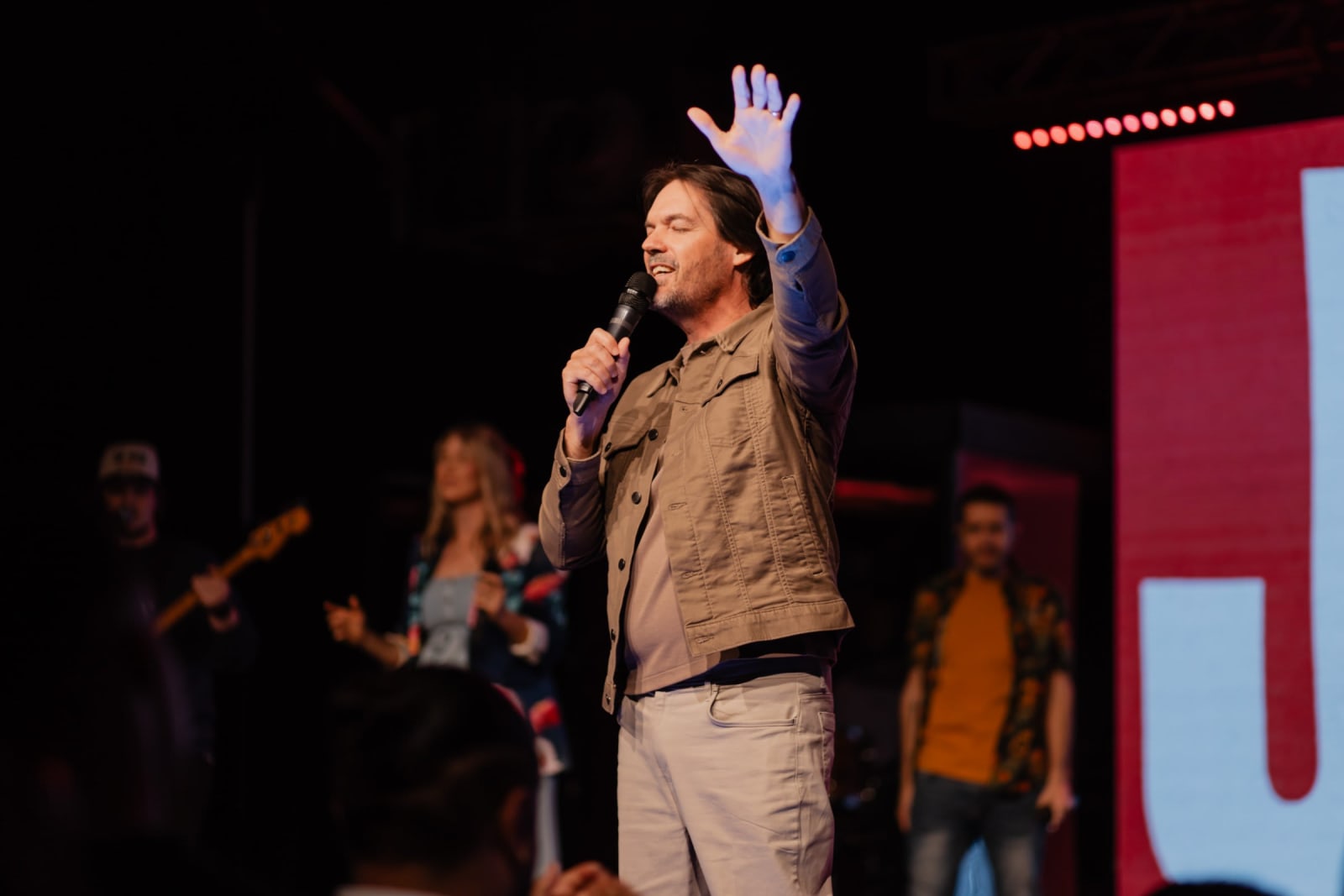 Nick Hindle praying with lifted hand / gwinnett + stage