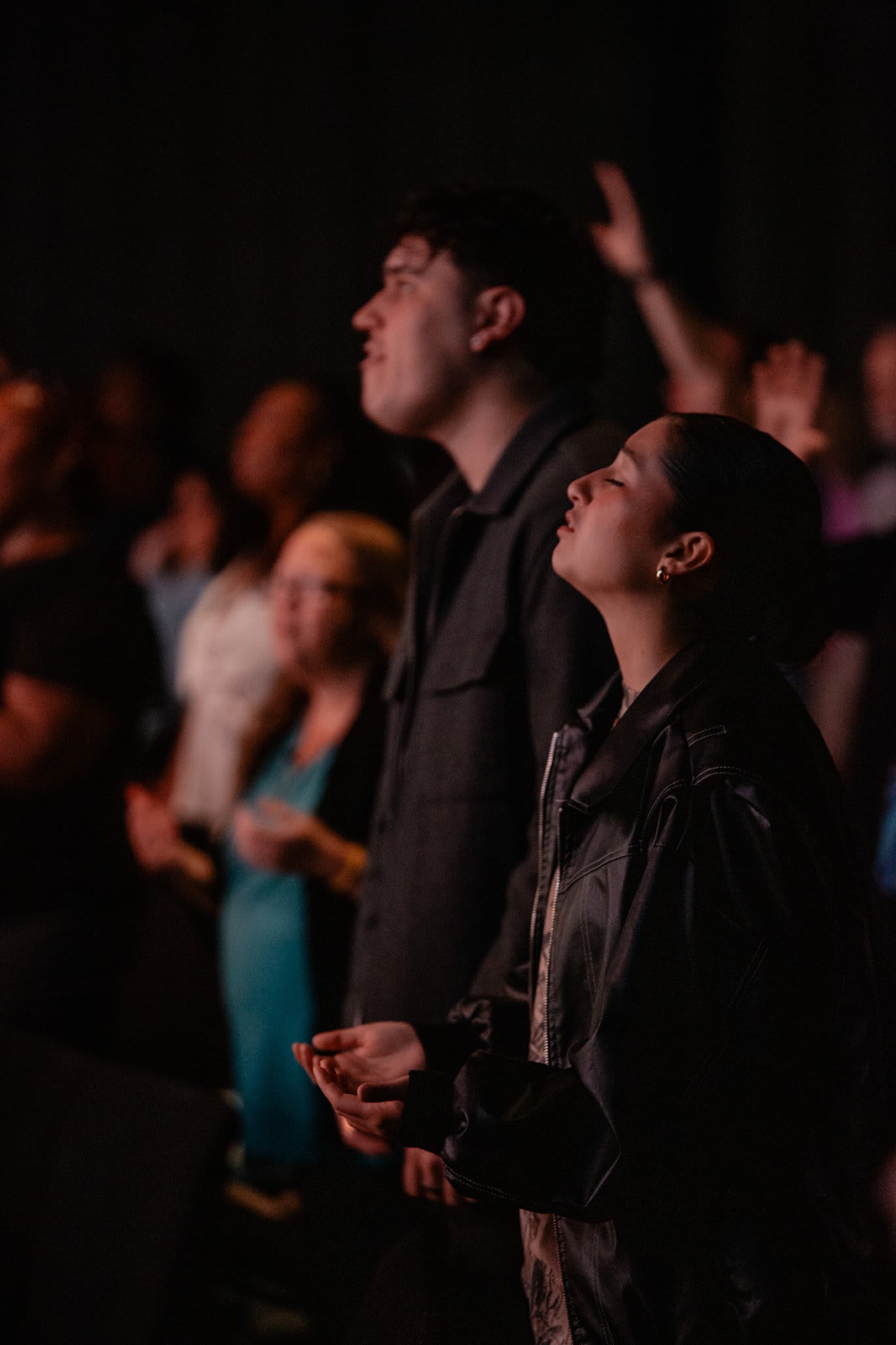 Congregation worshipping with hands raised / Gwinnett