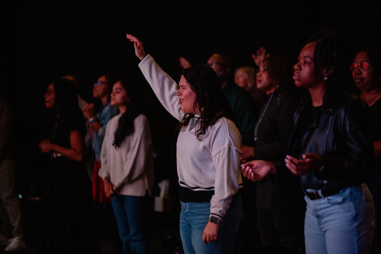 Congregation in worship with hands raised / Gwinnett