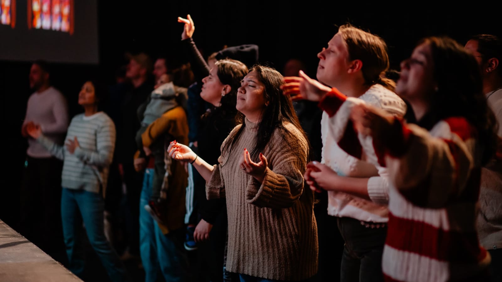 woman with hands stretched out in worship / gwinnett