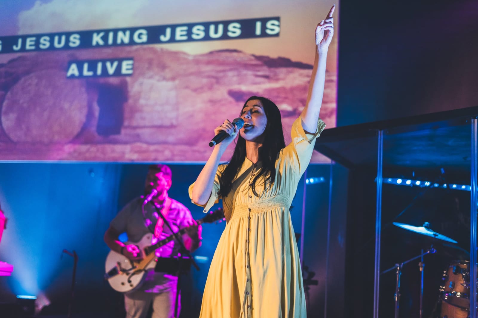 female worship singer with arm raised singing / kennesaw