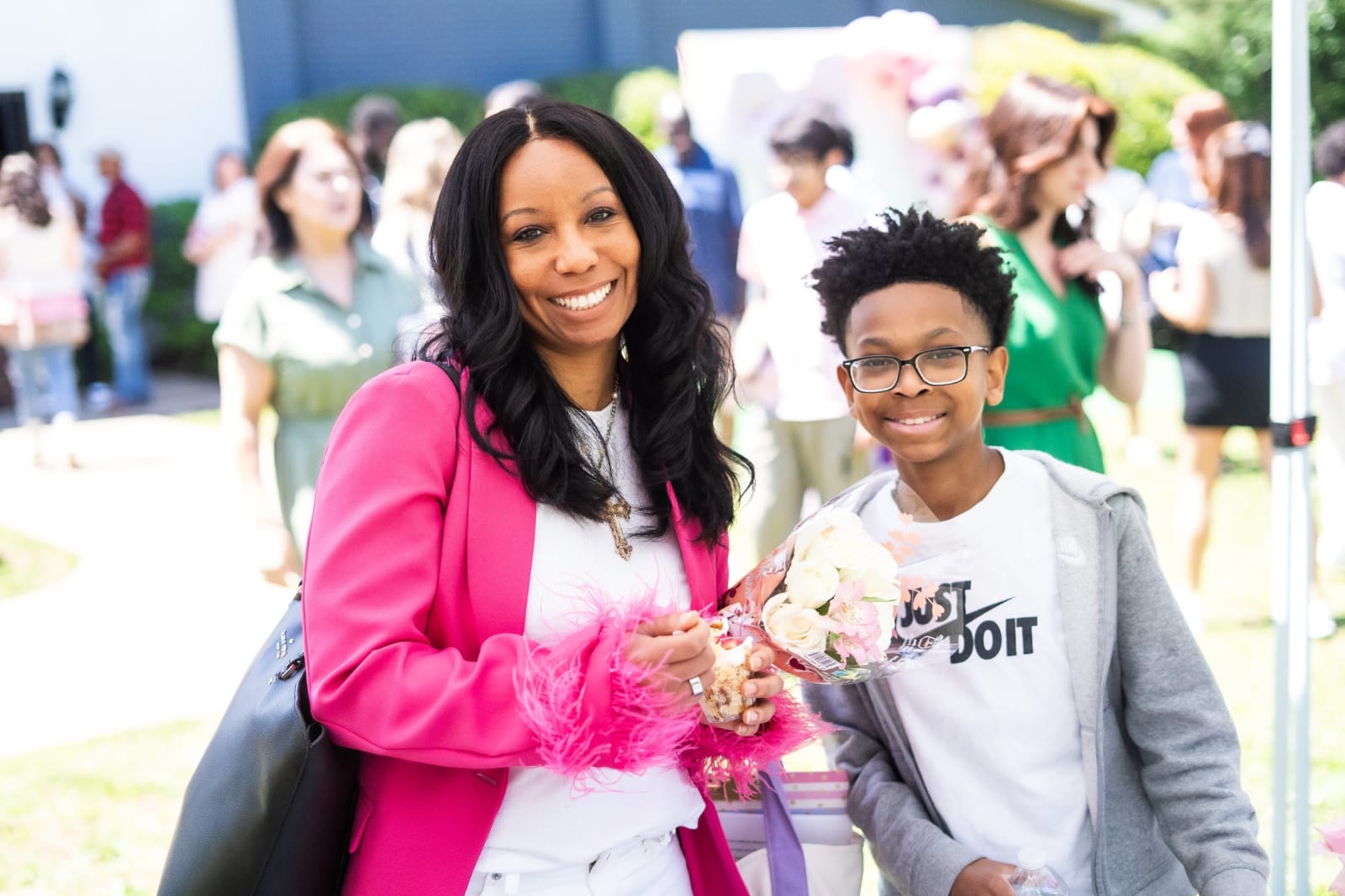 woman and young boy smiling with flowers / kennesaw