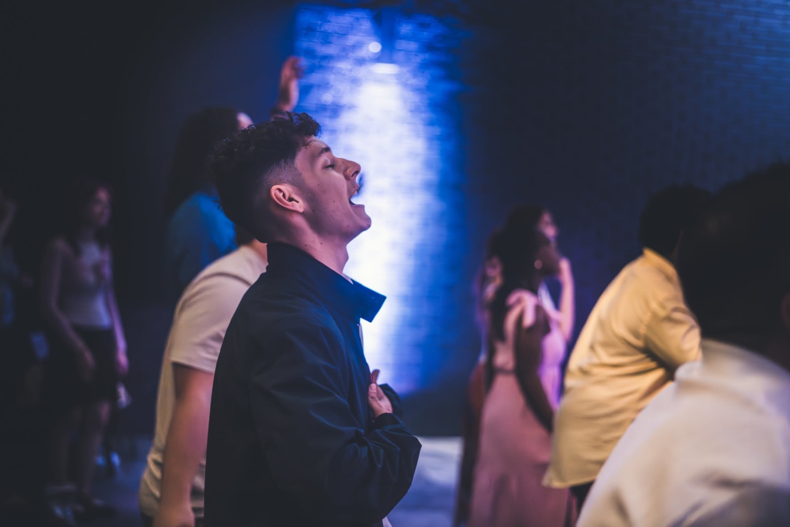 young man worshipping during service / kennesaw