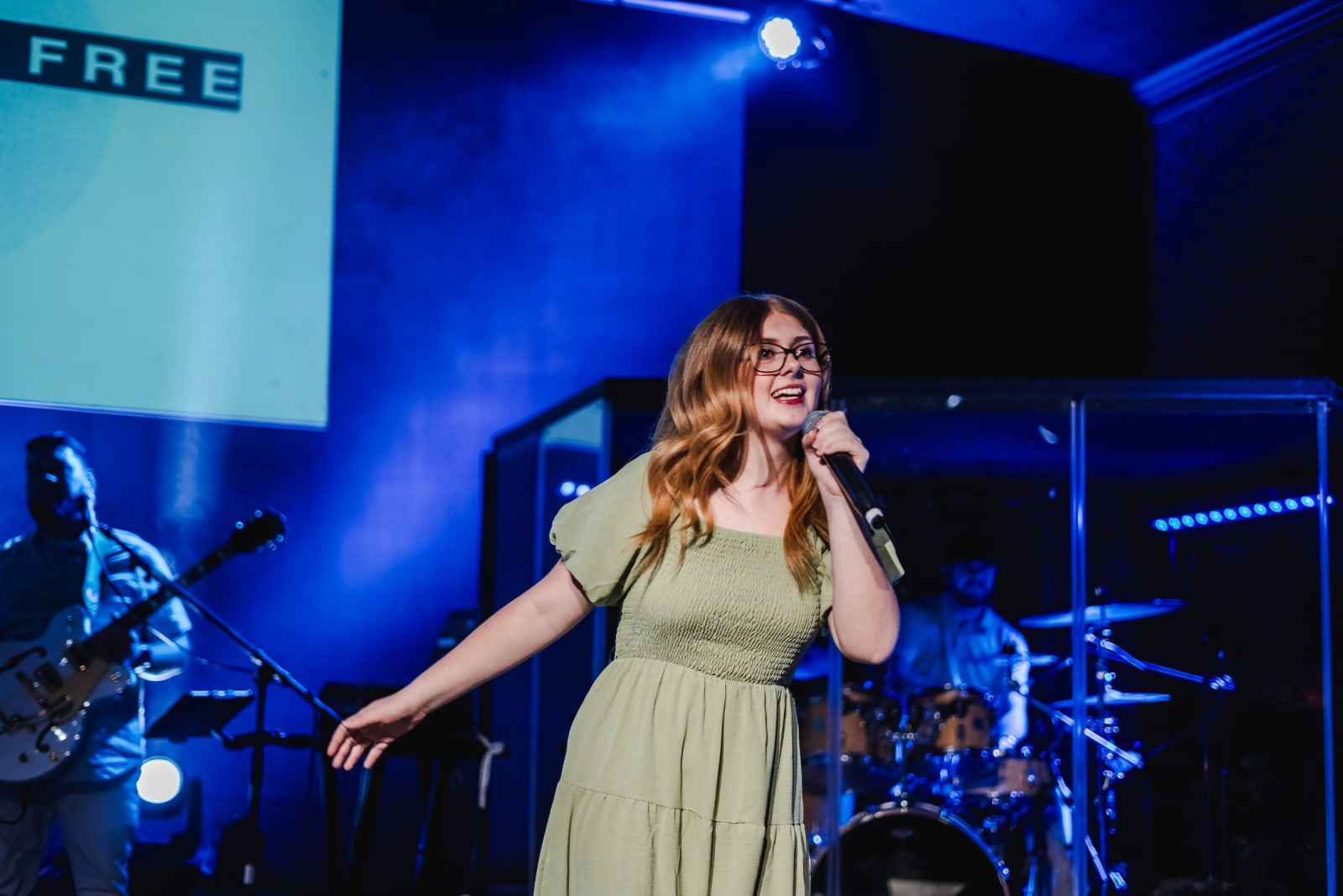 female worship singer singing on stage / kennesaw