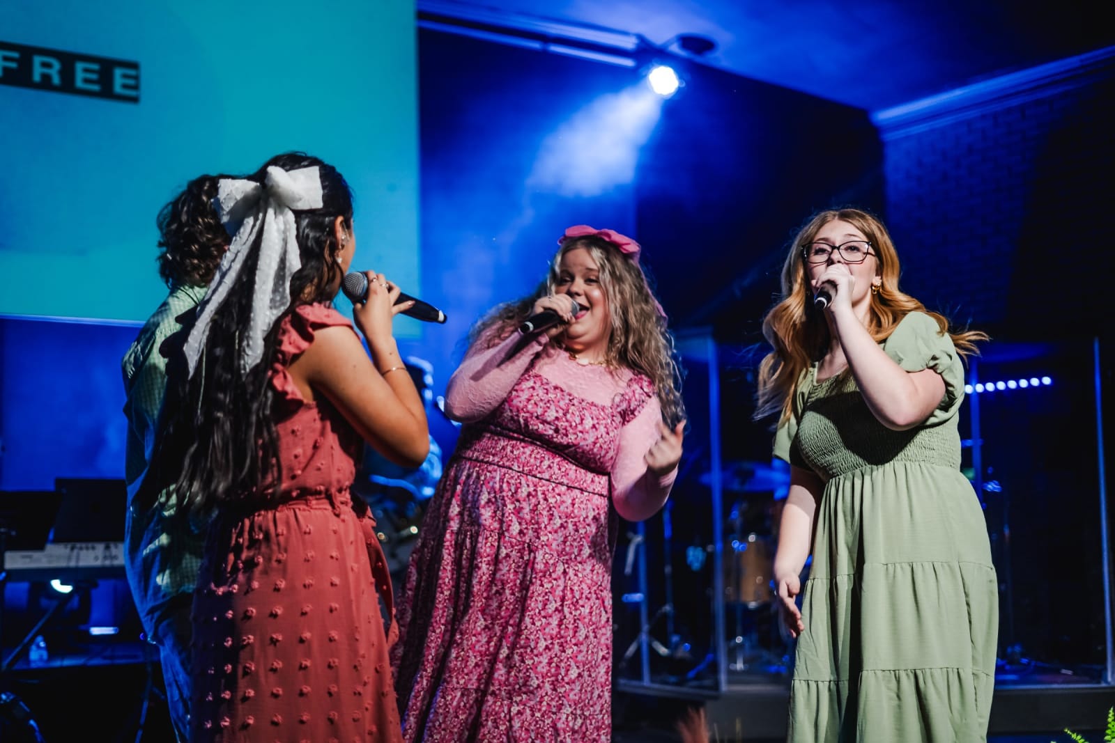 three female worship singers on stage / kennesaw