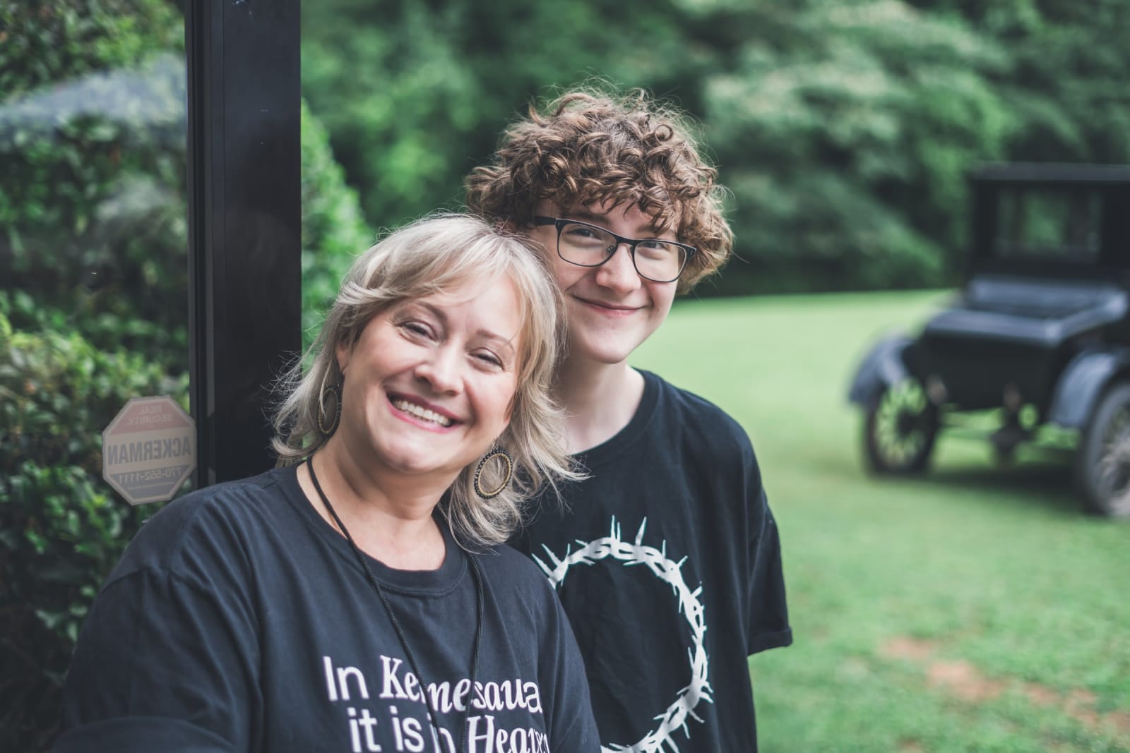 woman and teenage boy smiling outdoors / kennesaw