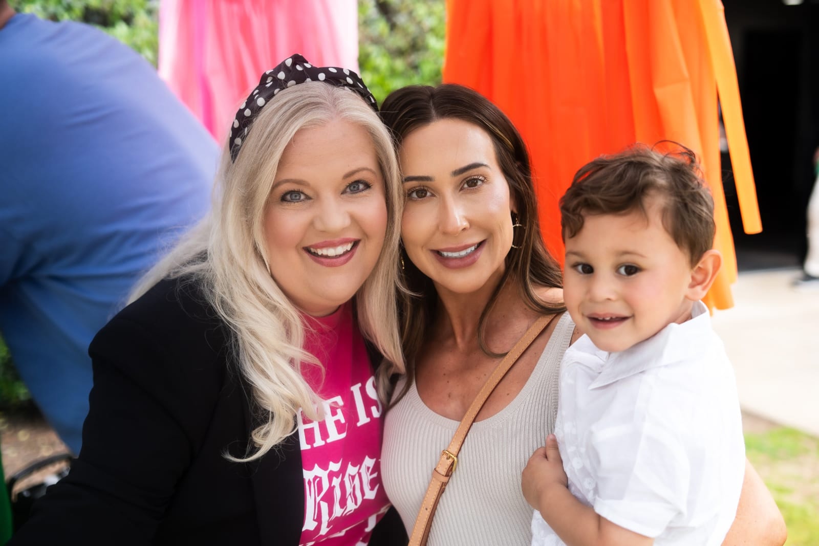 two women with a young child smiling / kennesaw