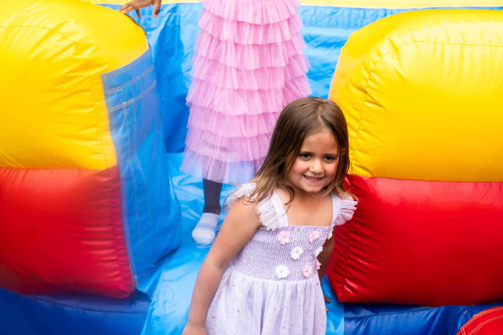 young girl smiling at bounce house / kennesaw